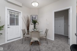 Dining area featuring gray carpet flooring and light-toned wall paint - 
