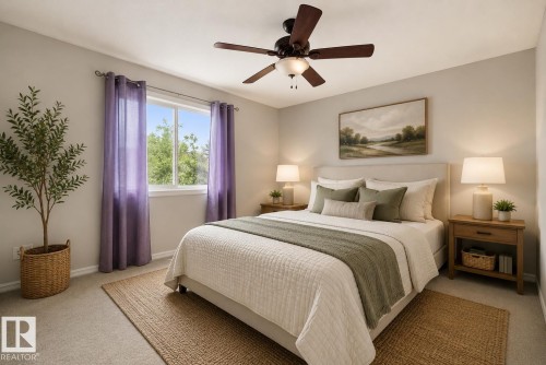 Spacious room featuring neutral carpeting, a large window, and a ceiling fan with integrated lighting - 2369 27 Avenue, Edmonton, AB 