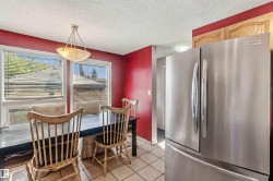 Dining area featuring a stainless steel French door refrigerator - 