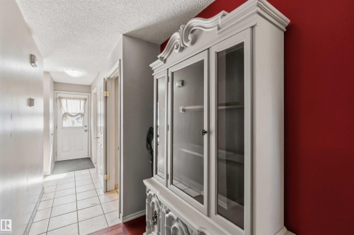 Foyer with white paneled door, ceiling-mounted light fixture, and tile flooring - 14121 23 Street, Edmonton, AB 