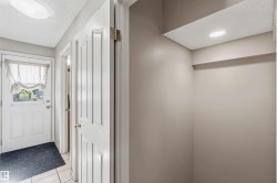 Entryway featuring a white paneled door with glass insert, ceramic tile flooring, and neutral wall tones - 
