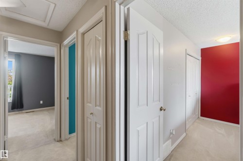 Central hallway with neutral carpeting and ceiling-mounted lighting - 14121 23 Street, Edmonton, AB 