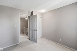 Carpeted room featuring a ceiling-mounted light fixture, light gray wall paint, and white trim - 