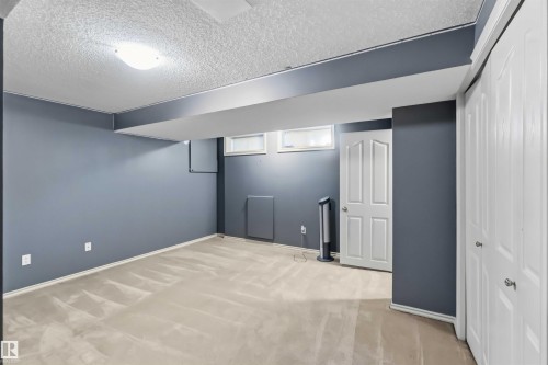 Finished room featuring gray walls and light-toned carpet flooring - 14121 23 Street, Edmonton, AB 