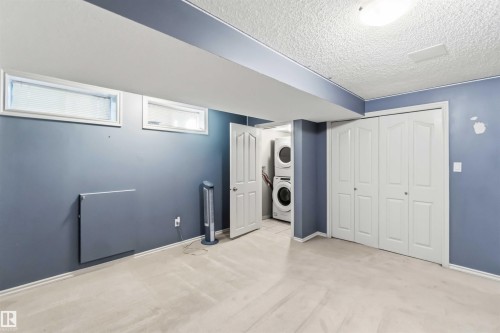 Finished room with light flooring, recessed lighting, and two horizontal windows with blinds - 14121 23 Street, Edmonton, AB 