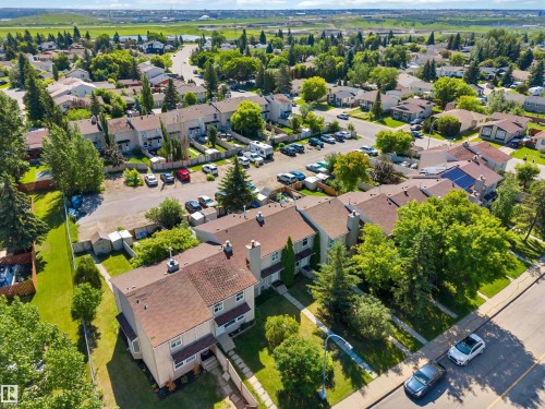 Aerial perspective showcasing a residential community with townhomes and detached houses - 14121 23 Street, Edmonton, AB 