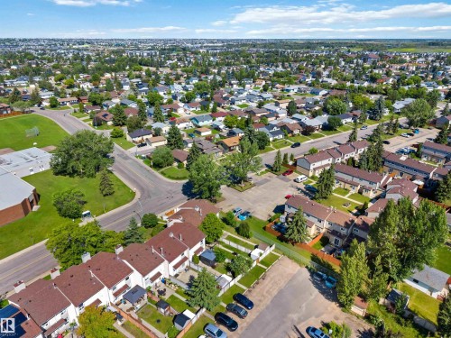 Aerial perspective showcasing a residential neighborhood with numerous detached homes and townhomes - 14121 23 Street, Edmonton, AB 