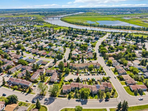 Aerial perspective showcasing a developed residential area with numerous single-family homes and multi-unit residences - 14121 23 Street, Edmonton, AB 