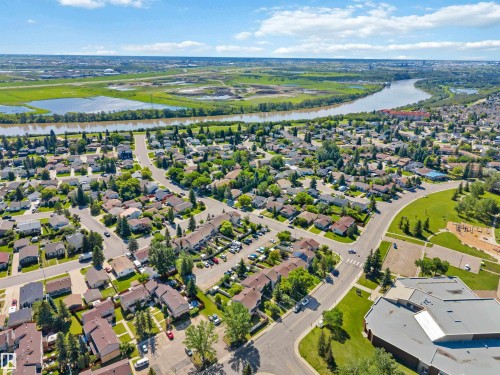Residential neighborhood with varied housing styles, mature trees, and paved streets - 14121 23 Street, Edmonton, AB 