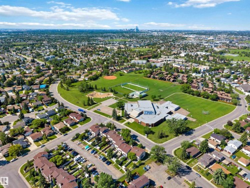 Aerial panorama featuring a suburban residential area with numerous single-family homes and multi-unit residences - 14121 23 Street, Edmonton, AB 