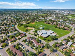 Aerial panorama featuring a suburban residential area with numerous single-family homes and multi-unit residences - 