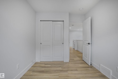 Room featuring light wood-finish flooring and white walls - 1915 164 Street, Edmonton, AB 