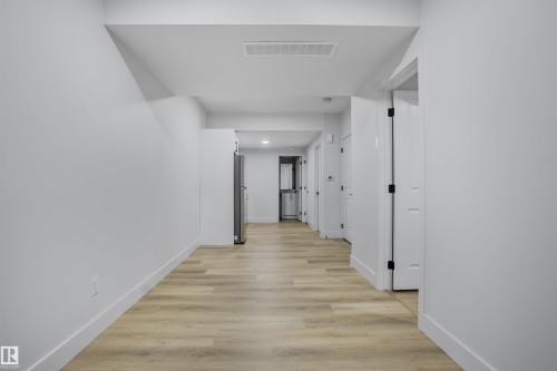 Contemporary hallway with light wood-finish flooring - 1915 164 Street, Edmonton, AB 