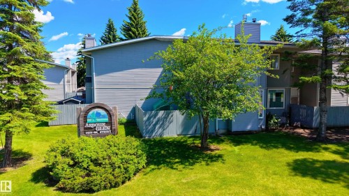 Multi-level building with gray siding and white trim - 10 1415 62 Street, Edmonton, AB 