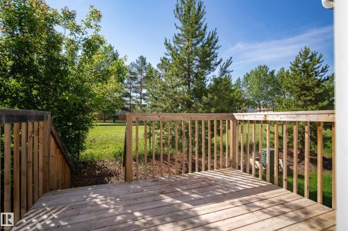 Expansive wooden deck with natural wood railing and privacy paneling - 11 4205 30 Street, Edmonton, AB 