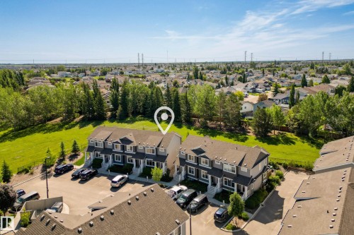Townhome community featuring gray siding, white trim, and brown shingle roofs - 11 4205 30 Street, Edmonton, AB 
