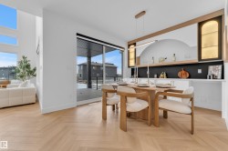 Dining space featuring herringbone wood-finish flooring - 
