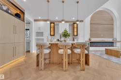 Central kitchen island with a light-toned countertop and pendant lighting - 