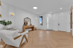 Light wood-finish herringbone flooring in an entry area - 