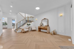 Light wood-finish herringbone flooring extending throughout the space - 