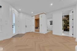 Herringbone wood-finish flooring throughout the entryway - 