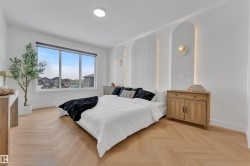 Spacious room featuring herringbone wood-finish flooring - 