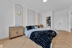Herringbone wood-finish flooring complements the bright white walls and recessed lighting - 