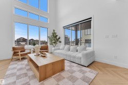 Living area featuring soaring ceilings and extensive window fenestration - 