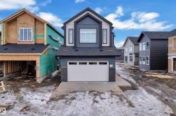 Modern facade featuring blue horizontal siding, light gray vertical siding, and dark gray vertical trim accents - 