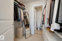 Walk-in closet featuring built-in shelving, hanging rods, and integrated drawer storage - 
