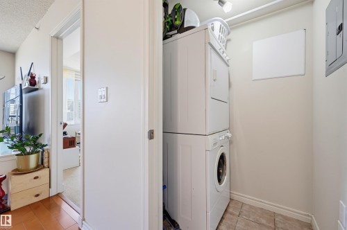 Dedicated laundry area featuring a stacked washer and dryer unit - 1103 10180 104 Street, Edmonton, AB 
