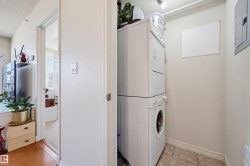 Dedicated laundry area featuring a stacked washer and dryer unit - 
