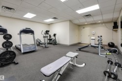 Dedicated fitness area featuring cardio equipment, strength training machines, free weights, and durable rubber flooring - 