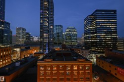 Downtown cityscape featuring a mix of modern high-rise and historic brick buildings - 