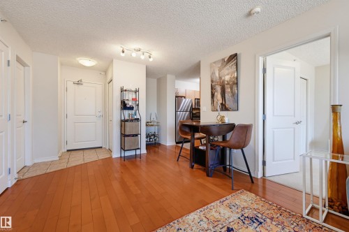 Welcoming entry area with wood-finish flooring transitioning to tile - 1103 10180 104 Street, Edmonton, AB 