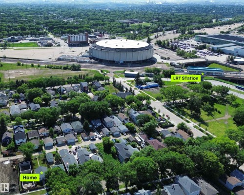 Aerial perspective showcasing the residential neighborhood with a prominent stadium and Light Rail Transit (LRT) station in the background - 11941 78 Street, Edmonton, AB 