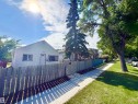 Gable-roof property featuring white siding and brown trim - 11941 78 Street, Edmonton, AB 