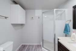 Corner shower with clear glass enclosure and frosted panels - 