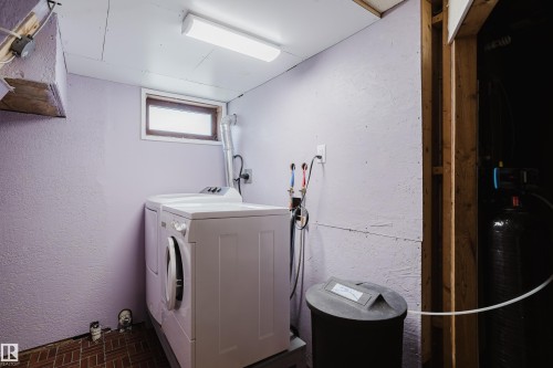 Dedicated laundry area featuring a front-loading washing machine and top-loading dryer - 212 Homestead Crescent, Edmonton, AB 