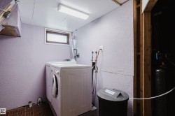 Dedicated laundry area featuring a front-loading washing machine and top-loading dryer - 