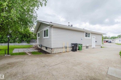 Gray siding exterior with white trim windows and a side entrance - 212 Homestead Crescent, Edmonton, AB 