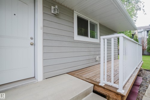 Front entrance featuring light gray siding and a white door with two round knobs - 212 Homestead Crescent, Edmonton, AB 