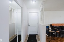 Entryway featuring light-toned flooring, a paneled entry door, and track lighting - 