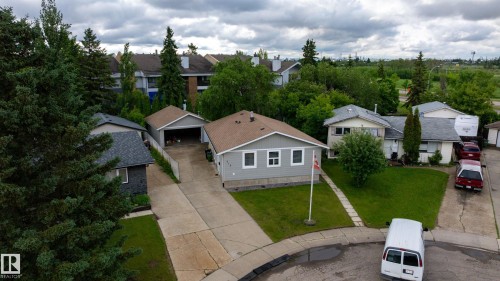 Single-story residence featuring light gray siding, white trim, and a brown shingle roof - 212 Homestead Crescent, Edmonton, AB 