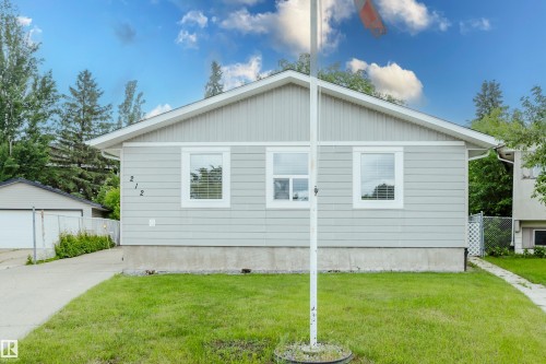Light gray siding exterior with white trim and a contrasting dark gray foundation - 212 Homestead Crescent, Edmonton, AB 