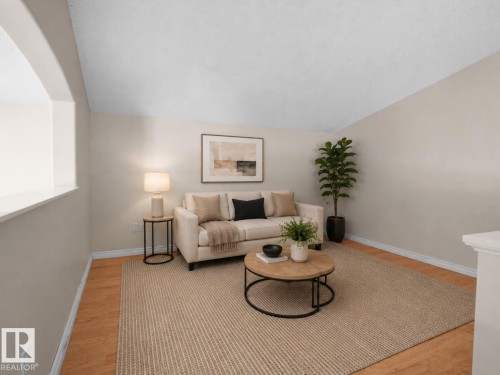 Living area with wood-finish flooring and neutral wall tones - 1855 Mill Woods Rd E Nw, Edmonton, AB 