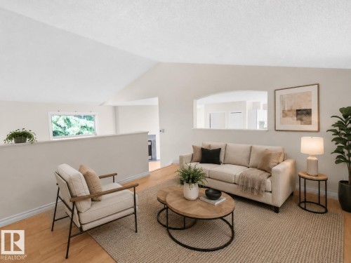 Bright living area featuring wood-finish flooring and vaulted ceilings - 1855 Mill Woods Rd E Nw, Edmonton, AB 