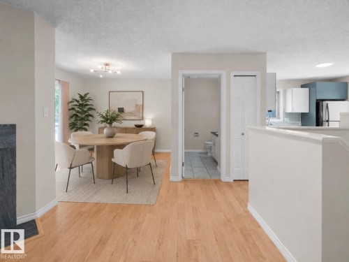 Open-concept living area with light-toned wood-finish flooring - 1855 Mill Woods Rd E Nw, Edmonton, AB 