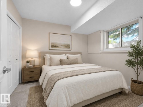 Spacious room featuring carpeted flooring, a large window, and light-toned walls - 1855 Mill Woods Rd E Nw, Edmonton, AB 