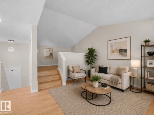 Vaulted ceilings enhance this living area featuring wood-finish flooring - 1855 Mill Woods Rd E Nw, Edmonton, AB 